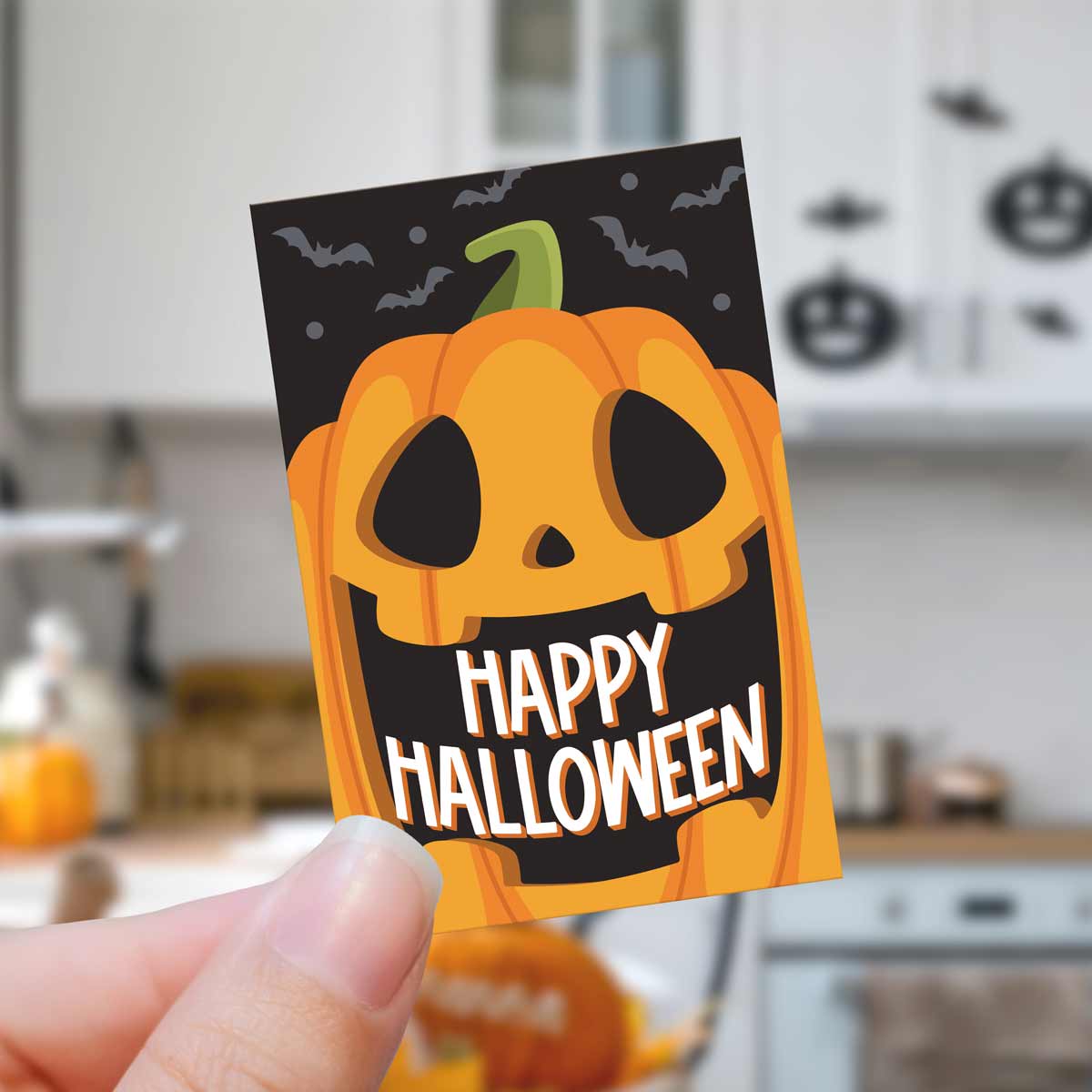 Halloween-themed card with a pumpkin and 'Happy Halloween' text held in a hand.
