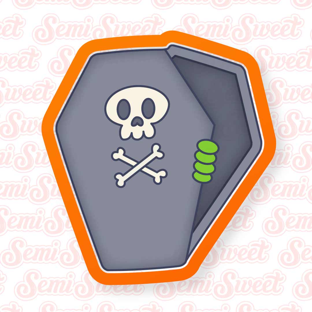 A coffin-shaped Halloween decoration or sticker with a gray face, white skull and crossbones, green teeth detail, and a bright orange border, shown on a white background with a repeating 'SemiSweet' watermark.