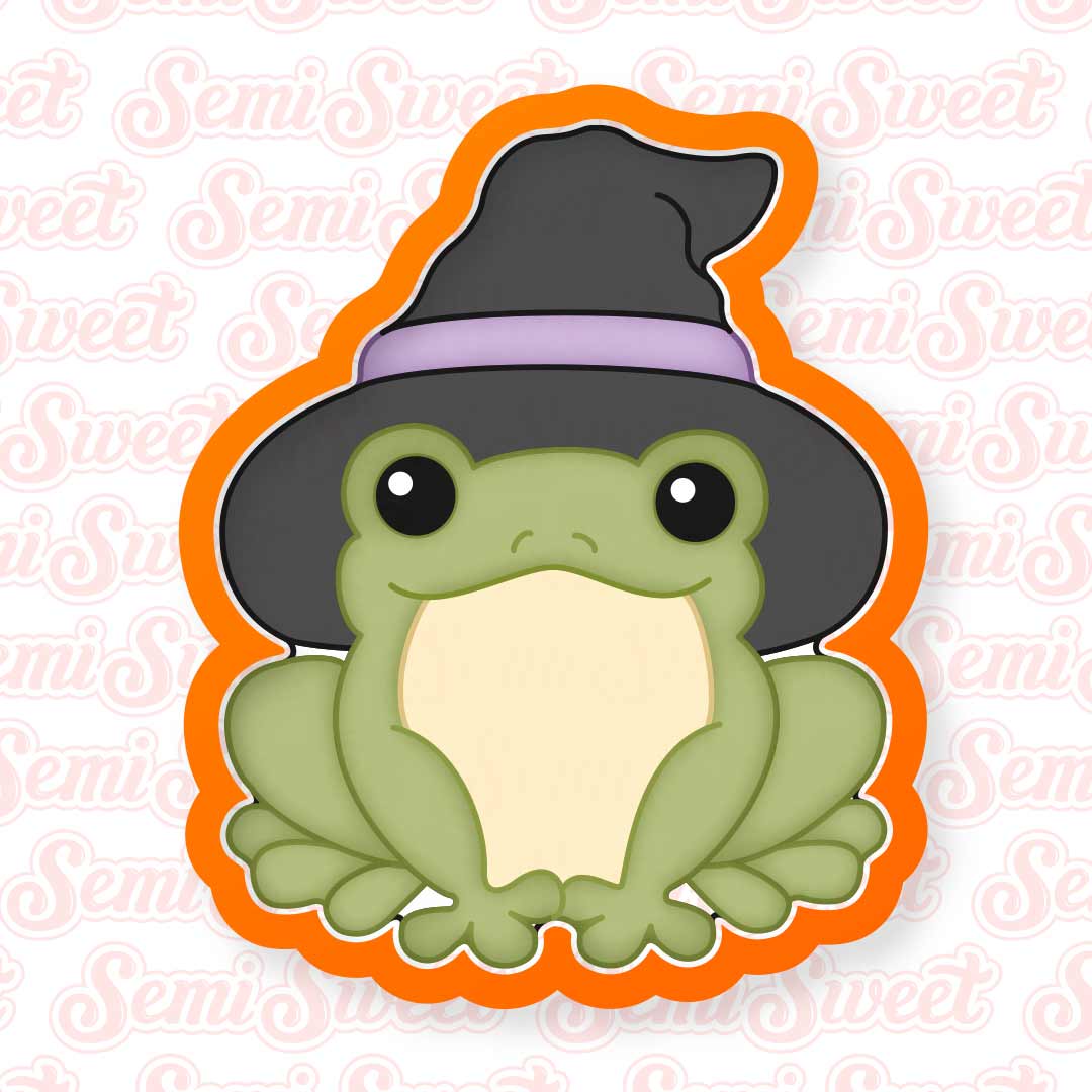 A cookie cutter featuring a cute green frog wearing a black witch hat with a purple band, outlined in orange, shown on a white background with a faint repeating 'SemiSweet' watermark.