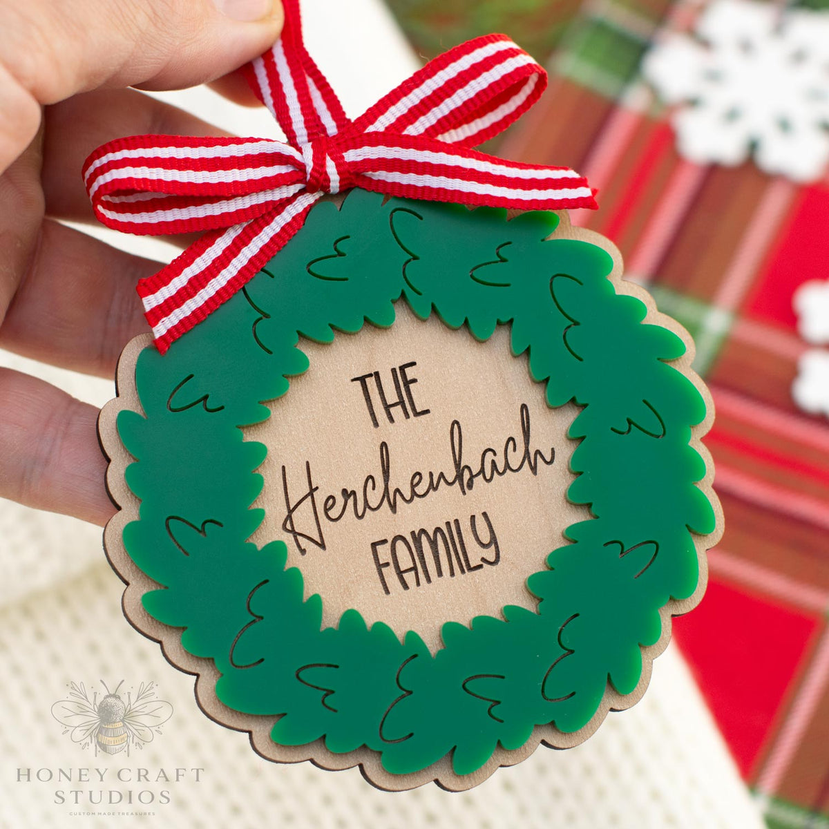 Personalized Christmas wreath ornament made of acrylic and wood.